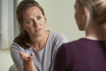 Young woman discussing problems with a counsellor